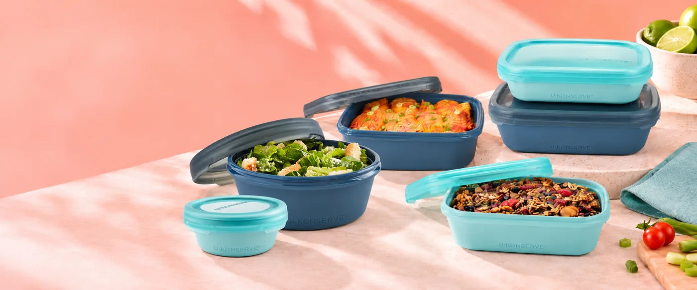 U-Konserve Bounce Box silicone containers with enchiladas, baked oats and salad on a coral kitchen bench